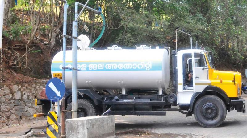 A taker lorry fills water at KWA office premises in Vellayambalam.