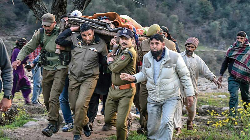 Police officers and locals carry an injured for treatment to a hospital after firing and mortar shelling by the Pakistani Army along the LoC in Krishna Ghati sector of J&K. 	 PTI