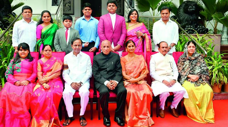 Governor E.S.L. Narasimhan and his wife Vimala (seated fourth and fifth from left), CM K. Chandrasekhar Rao (third from left) and his wife Shobha Rao (second from left), and minister Mahmood Ali (sitting second from right) and his wife Nasreen Fathima (sitting extreme right) after the swearing-in ceremony of the Chief Minister at Raj Bhavan in Hyderabad on Thursday. Others in the photo are former minister K.T. Rama Rao (standing extreme right), his wife Shailima Rao (second from right) and their son Himanshu (third from right) and daughter Alekhya (sitting extreme left); TRS MP Kavitha (second from left), her husband Dr Anil Kumar (standing extreme left) and their sons Aditya and Aarya.