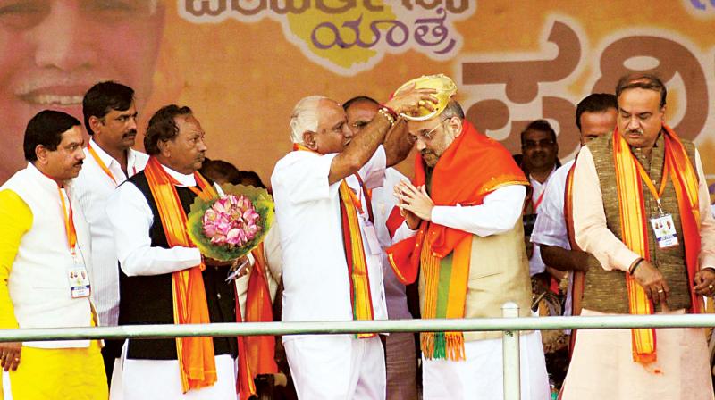 BJP national president Amit Shah being felicitated by partys state chief B. S. Yeddyurappa at the inaugural function of Parivarthana Yatra in Bengaluru on Thursday. (Photo: KPN)