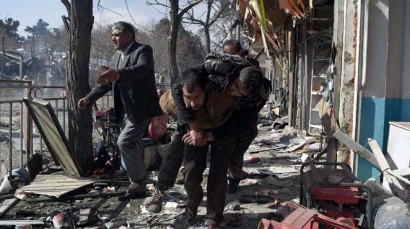 Near the blast site civilians walked through debris-covered streets carrying wounded on their backs as others loaded several bodies at a time into ambulances and private cars to take them to medical facilities around the city. (Photo: AFP)