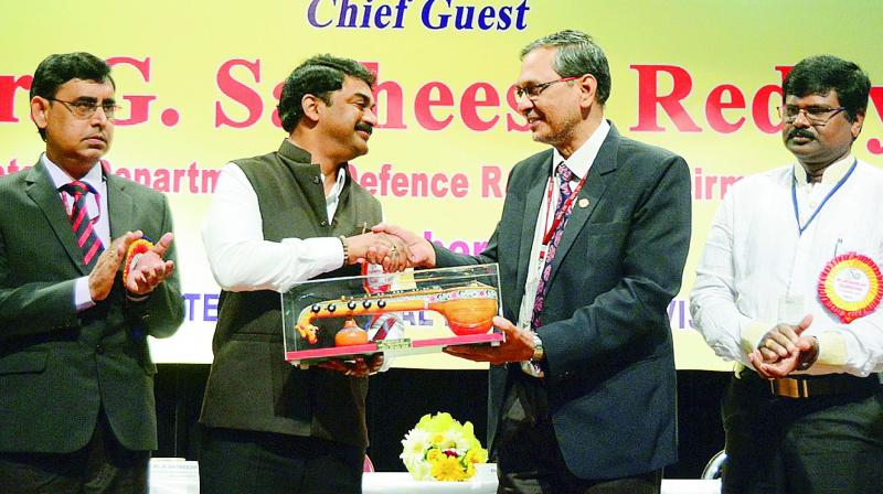 NSTL director Dr O.R. Nandagopan presents a memento to the chairman of the Defence Research and Development Organisation (DRDO) and secretary, Department of Defence Research and Development (DDR&D), Dr G. Satheesh Reddy at the 49th Raising Day Celebrations of NSTL in Visakhapatnam on Saturday. (Photo: DC)