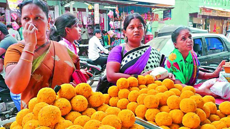 Women buy laddus in Dhoolpet on the eve of Raksha Bandhan. Every year during this time about 60 shops come up in the area.  (Photo:DC)