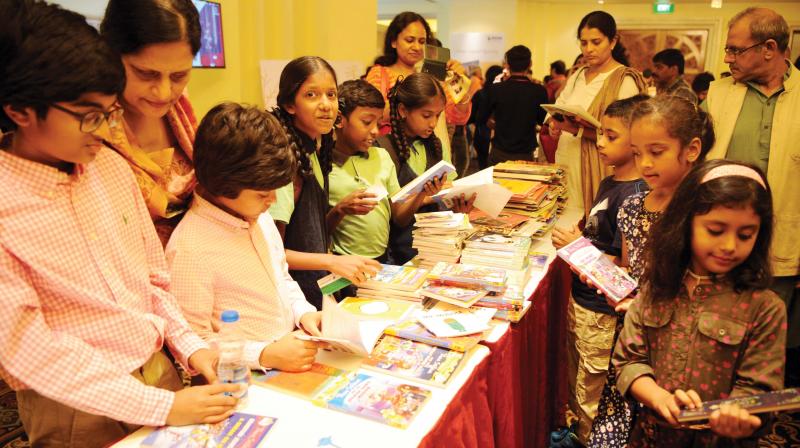 Visitors browse through books on display at an  exhibition at the Bengaluru Poetry Festival 2017.