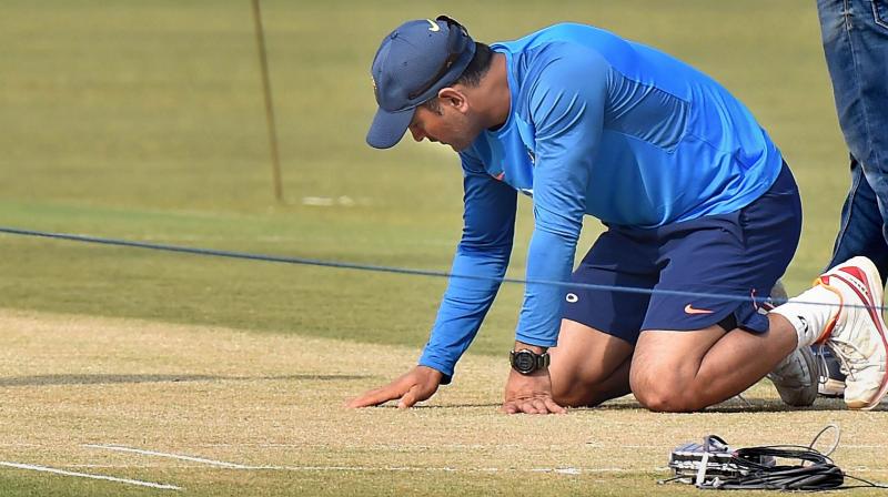 MS Dhoni headed straight to the 22-yard strip after dropping his kit bag and examined it minutely from both ends. (Photo: PTI)