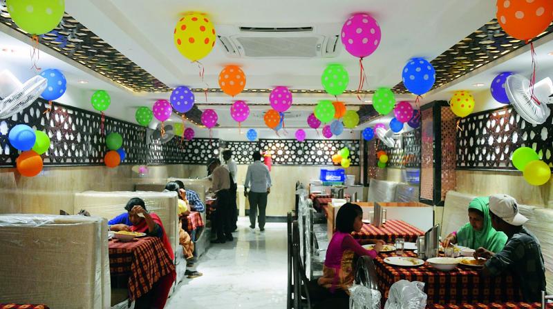 People relish food at the Madina Hotel that reopened on Wednesday. 	 (Image: DC)