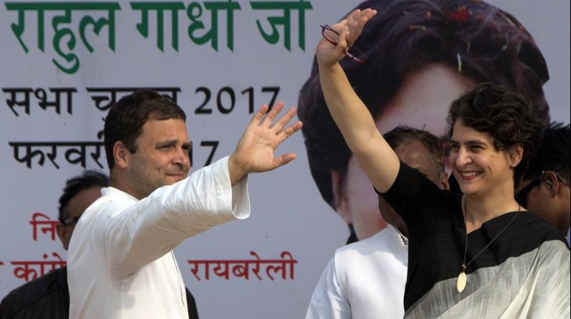 Congress party Vice President Rahul Gandhi and his sister Priyanka Vadra wave to supporters during an election campaign rally in Raebareli. (Photo: AP)