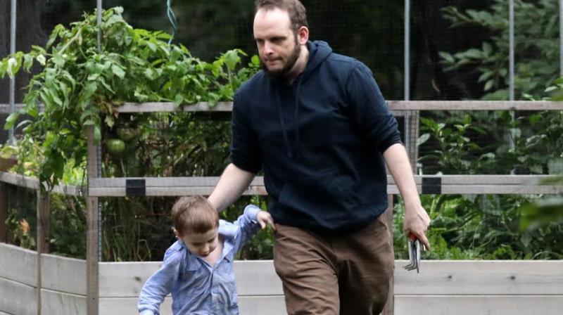 Canadian hostage Joshua Boyle and one of his children walk outside the Boyles family home in Smiths Falls, Ontario, Canada, on October 14, 2017. (Photo: AFP)