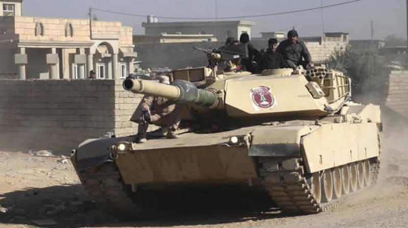 Government troops are backed by US-led coalition airstrikes against IS positions in the city.