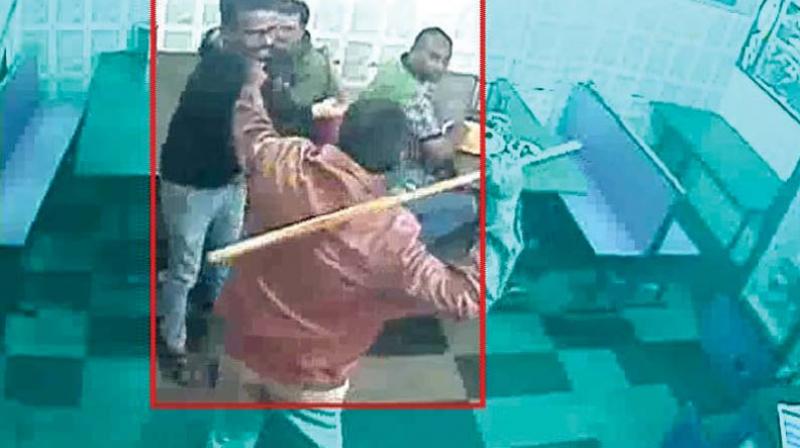 A video grab of ACP Manjunath Babu beating up the hotel owner