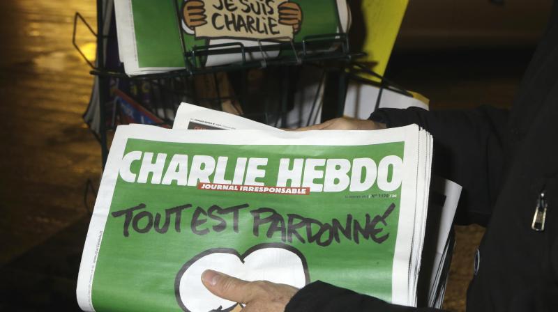 In this Wednesday, Jan. 14, 2015, file photo, a seller of newspapers stocks several Charlie Hebdo newspapers at a newsstand in Nice, France. (Photo: AP)