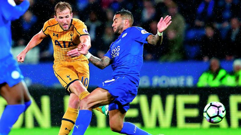Tottenham Hotspurs Harry Kane (left) shoots past Leicester Citys Danny Simpson to score his third goal in their English Premier League match at the King Power Stadium in Leicester on Thursday. Tottenham won 6-1. (Photo: AP)