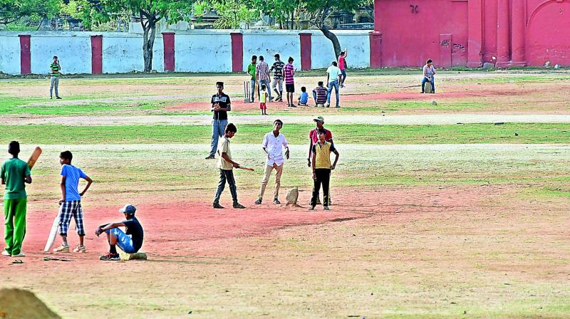 Children play cricket at the Parade Ground on Friday. (Photo: DC)