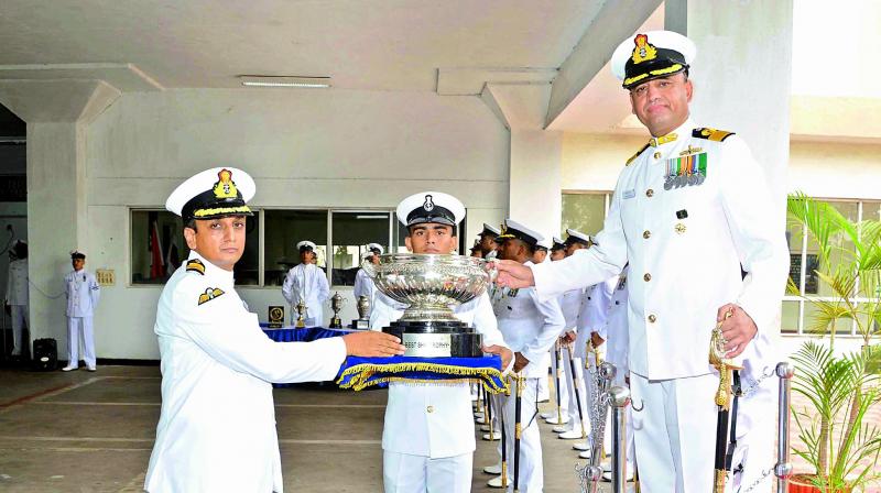 Naval Officer-in-Charge, Andhra Pradesh Commodore Sanjeev Issar presents the Best Ship award to INS Kozhikode during the Annual Flotilla Awards Ceremony for 2016-17 at Naval Dockyard premises in Vizag on Friday.