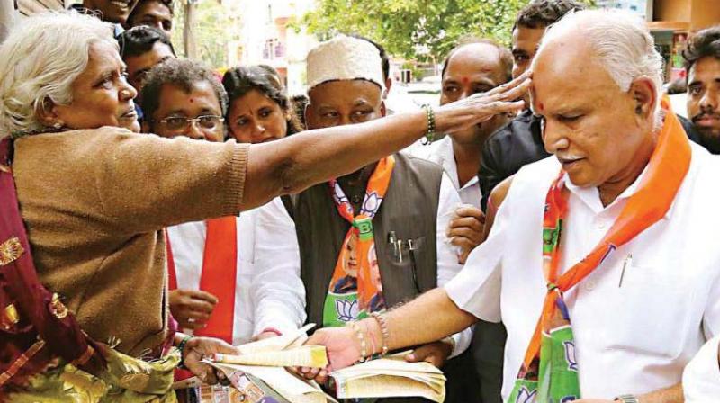 In this file photo, BJP state president and former CM B.S. Yeddyurappa participates in a Dalit outreach programme