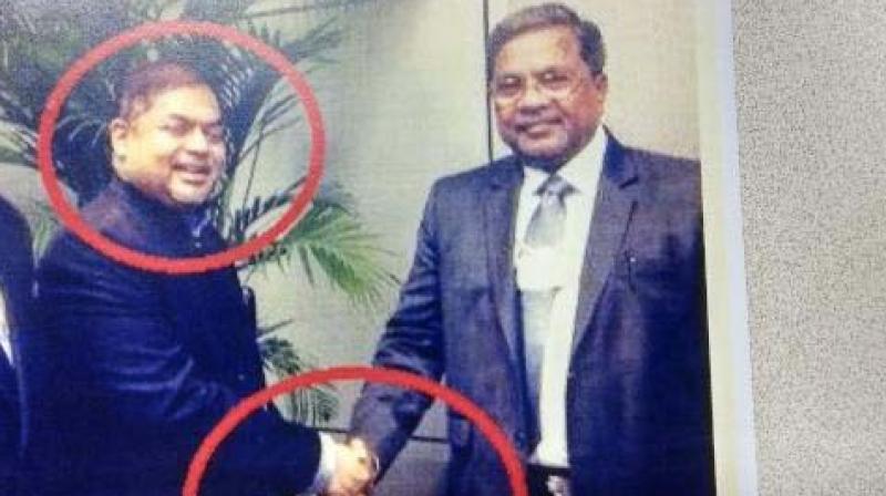 A pic made public by the BJP showing CM Siddaramaiah with Vijay Ishwaran.