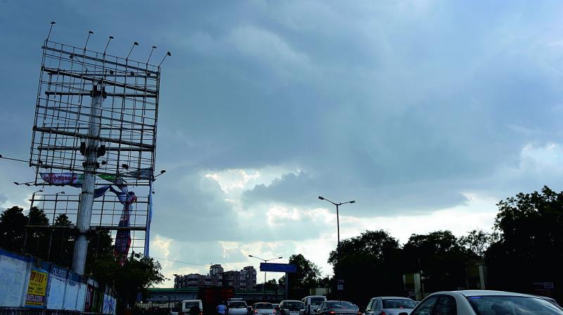 Heavy wind left hoardings torn in Hyderabad on Friday. The city had also witnessed a short drizzle, bringing down temperature in some parts. (Photo: DC)