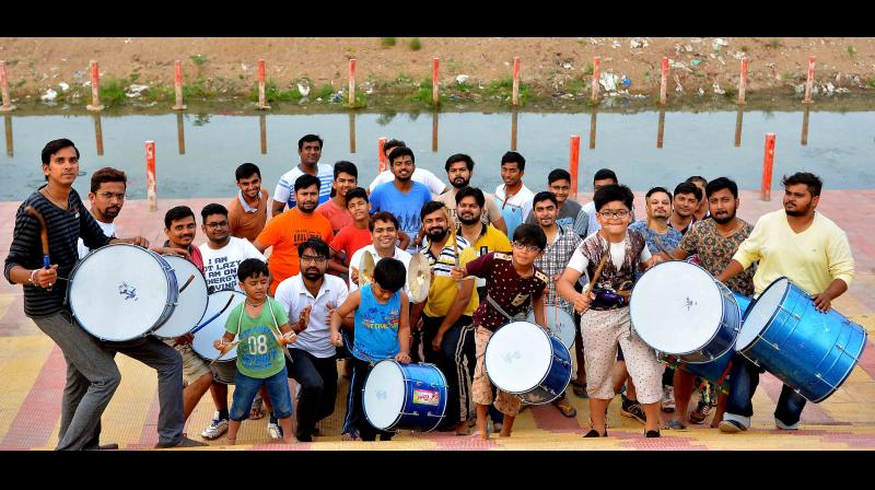 Jain community youngsters practice drums at Krishnaveni Pushkar ghat in Vijayawada on Wednesday. (Photo: DC)