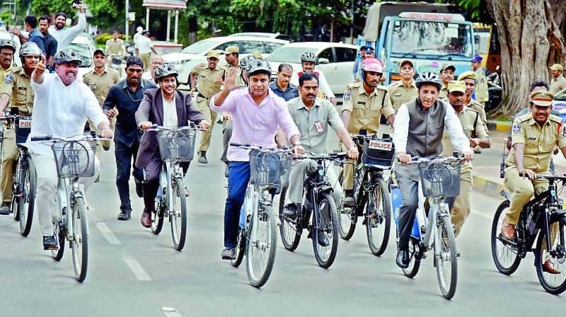 Governor E.S.L. Narasimhan and minister of municipal affairs and urban development K.T. Rama Rao cycle towards Raj Bhavan on Monday.