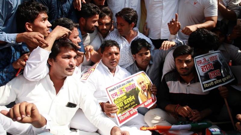 The Youth Congress activists Monday staged a protest near the residence of Union minister MJ Akbar, demanding his \immediate resignation\ over allegations of sexual misconduct by several women journalists. (Photo: Twitter | @IYC)