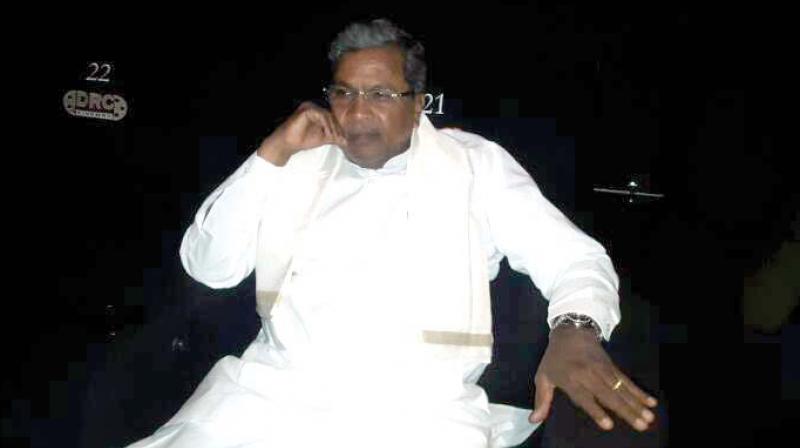 CM Siddaramaiah watching Raajakumara at a cinema in Mysuru on Sunday.