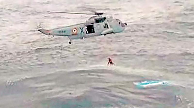 A Navy helicopter rescues fishermen in the wake of cyclone Ockhi, in Lakshadweep Saturday. (Photo: AP)