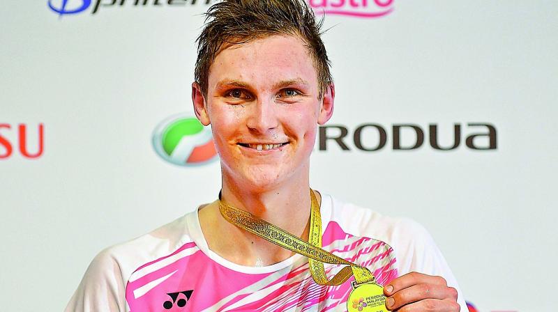 Viktor Axelsen of Denmark poses with his medal after defeating Kenta Nishimoto of Japan in the mens singles final at the Malaysia Masters badminton tournament in Kuala Lumpur on Sunday. (Photo: AFP)