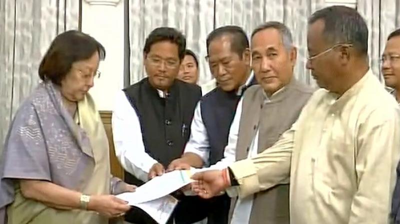 BJP MLAs with supporting MLAs meet Manipur Governor Najma Heptulla, staking claim to form the government. (Photo: ANI Twitter)