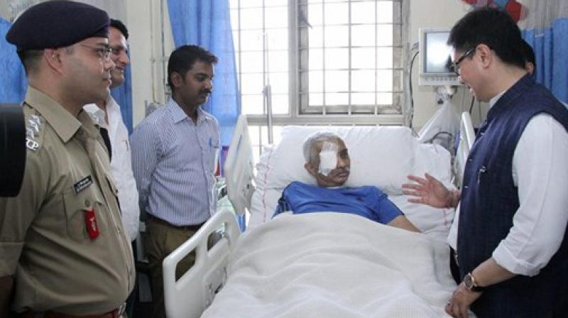 Minister of State for Home Affairs, Kiren Rijiju seeing the CRPF Commandant, Chetan Kumar Cheetah at AIIMS, who survived fatal bullet injuries in an encounter in Jammu and Kashmir in February this year, in New Delhi on Wednesday. (Photo: PTI)