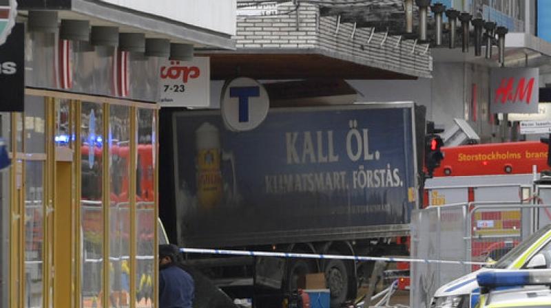 The rear of a truck, left, protrudes after it crashed into a department store injuring several people in central Stockholm, Sweden, Friday April 7, 2017. (Photo: AP)