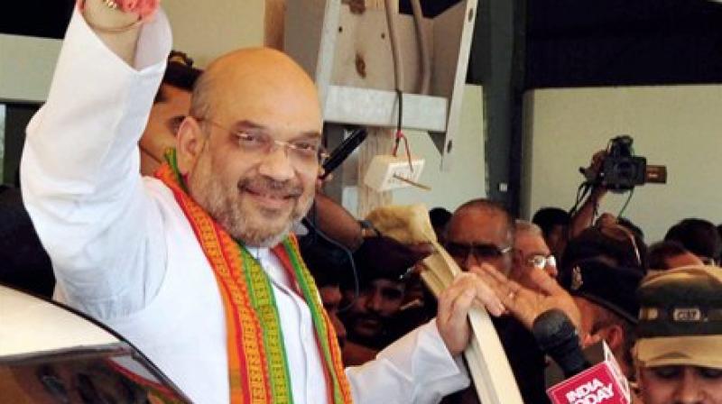 BJP President Amit Shah waves at supporters on his arrival in Hyderabad on Monday. (Photo: PTI)