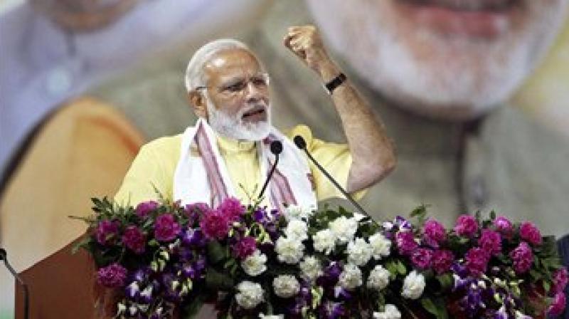 Prime Minister Narendra Modi addressing a public rally organized to celebrate the 3rd anniversary of NDA Government in the Centre in Guwahati on Friday. (Photo: PTI)