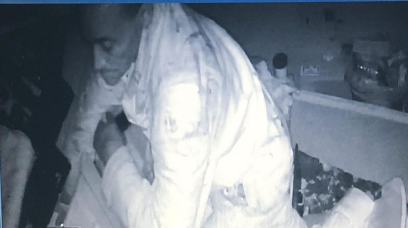 Surveillance camera grab of the burglar gorging on food at E&L Barbeque restaurant. (Photo: Facebook/ E&L Barbeque)