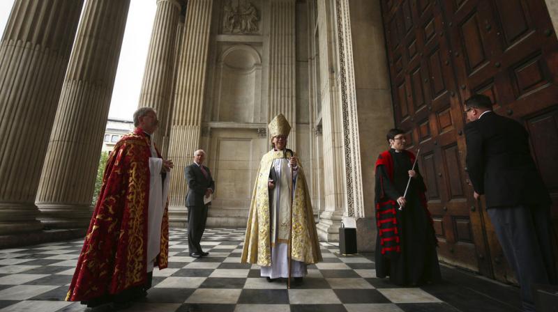 Sarah Mullally, centre, arrives to be installed as the 133d Bishop of London during a service at St Pauls Cathedral in London, Saturday May 12, 2018. Bishop Sarah had a career in the National Health Service as a nurse, before her ordination. (Photo: AP)