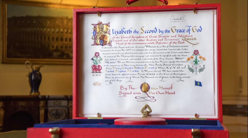 The design to the left of the text incorporates the red dragon of Wales along with the UKs floral emblems. It also includes three tiny red escallops from the Spencer family Arms, the family of Harrys mother, the late Princess Diana. (Photo: AP)