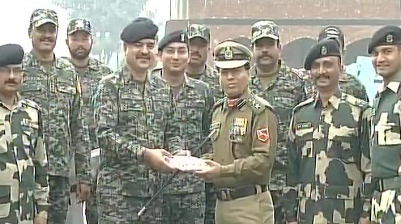 Security personnel from India and Pakistan exchange sweets at Wagah Border on the occasion of Indias Republic Day. (Photo: Twitter/ANI)