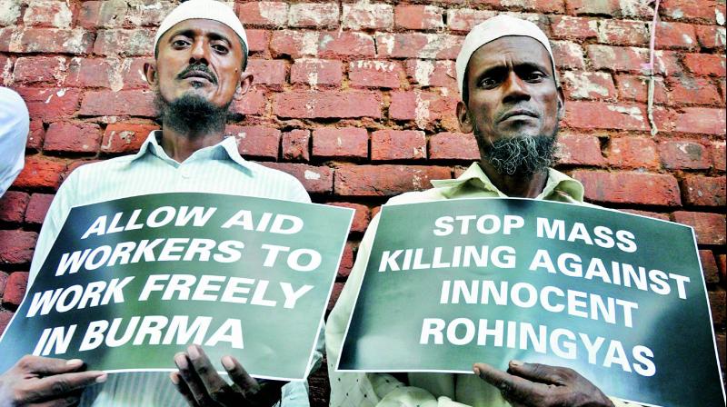 Rohingya Muslim refugees hold placards against human rights violations in Myanmar during a protest at Jantar Mantar in New Delhi on Tuesday. (Photo: PTI)