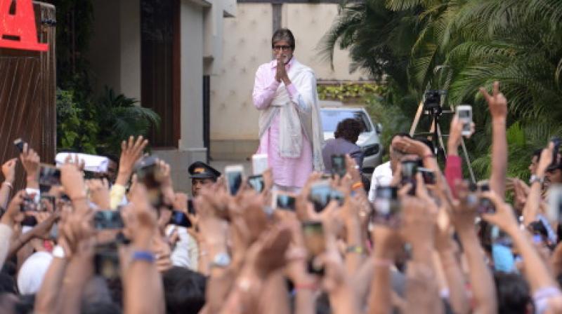 Amitabh Bachchan greeting his fans outside his residence.