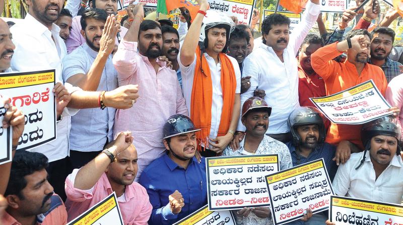 BJP Yuva Morcha members protesting against stone pelting on the residence of Hassan MLA Preetham Gowda, in Bengaluru on Thursday  (Photo: DC)