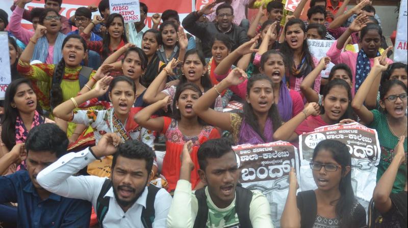 Students stage a protest demanding free bus pass, in Bengaluru on Saturday      (Image: DC)