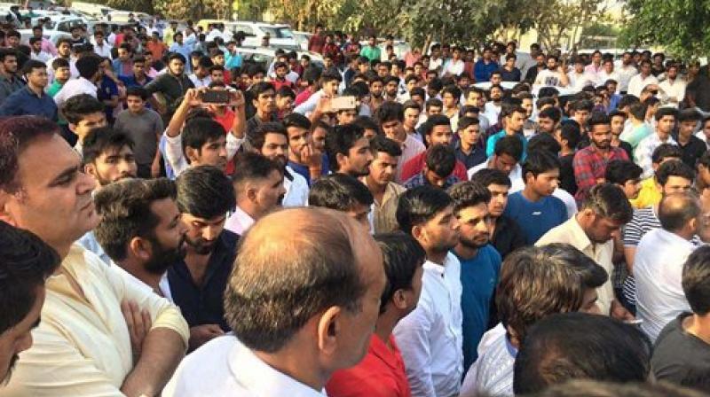 People holding a protest against African nationals over the death of a teenager allegedly due to drug supplied by Nigerians, in Greater Noida on Monday. (Photo: PTI)