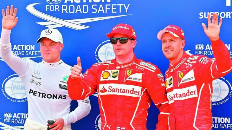 Kimi Raikkonen (centre), Sebastian Vettel (right) and Valtteri Bottas celebrate after winning the qualifying session in Monaco GP on Saturday in Monaco. (Photo: AFP)