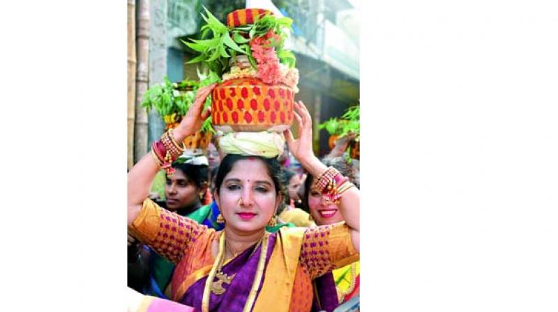 Devotees carrying bonam to offer it to the goddess at the temple.   (Image: DC)