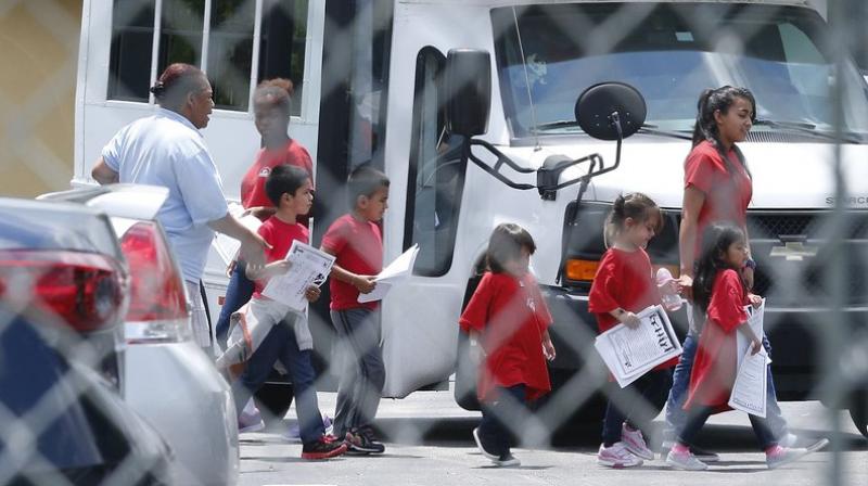 Migrant children walk off a bus at the Catholic Charities Msgr. Bryan Walsh Childrens Village in Cutler Bay. Congresswoman Debbie Wasserman Schultz said that children who range in age from newborns to 5 years old are being sheltered at this facility and His House Childrens Home in Miami Gardens. (Photo: AP)
