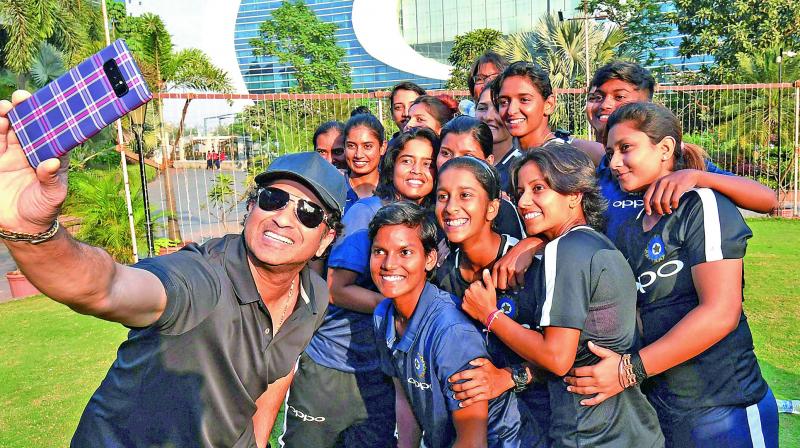 Former Indian batsman Sachin Tendulkar takes a selfie with members of the Indian womens cricket team at the Bandra Kurla Complex in Mumbai on Monday ahead of the sides departure to South Africa for a series. (Photo: AP)