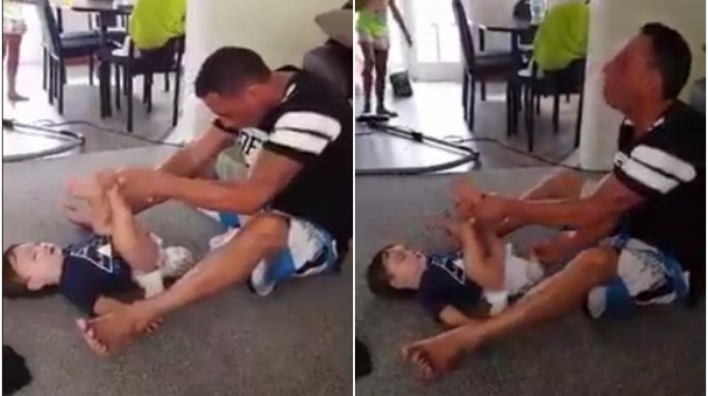 Reactions of the father while he tries to put on a new nappy (Photo: Facebook)