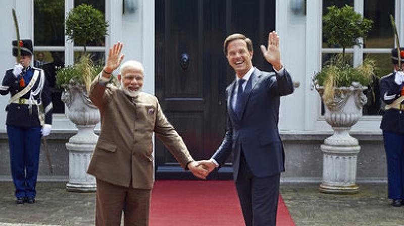 Indian Prime Minister Narendra Modi, left, and Dutch Prime Minister Mark Rutte shake hands upon their arrival at the Catshuis residence in The Hague, Netherlands, Tuesday, June 27, 2017. Modi has met his Dutch counterpart during a brief stop in the Netherlands on his way home from meeting President Donald Trump in Washington, D.C. (AP Photo/Phil Nijhuis)