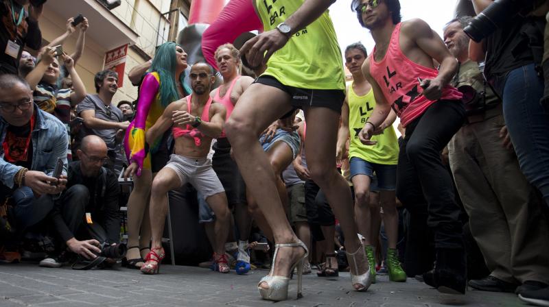 Participants take part in a Gay Pride high heels race in the Chueca district, a popular area for the gay community in Madrid, Spain, Thursday, June 29, 2017. Madrid is celebrating WorldPride 2017, a colorful mixture of vindication for sexual and gender diversity and all-night partying. Up to 3 million people are expected in the Spanish capital amid tight security measures. (AP Photo/Paul White)