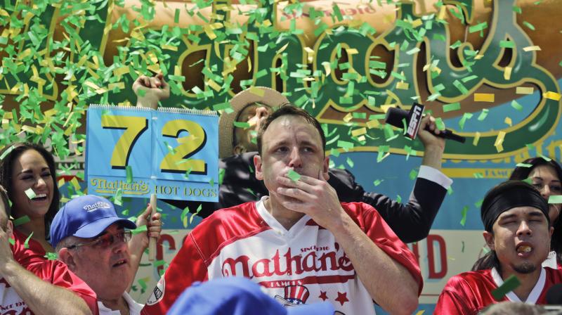 Joey Chestnut wins the Nathans Famous Hot Dog Eating Contest, marking his 10th victory in the event, Tuesday, July 4, 2017, in the Brooklyn borough of New York. He downed 72 hot dogs and buns in 10 minutes. (AP Photo/Bebeto Matthews)