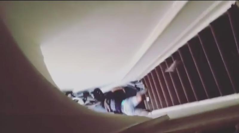 Shot from the footage showing Nkumbi lying at the bottom of the stairs. (Photo: Instagram)